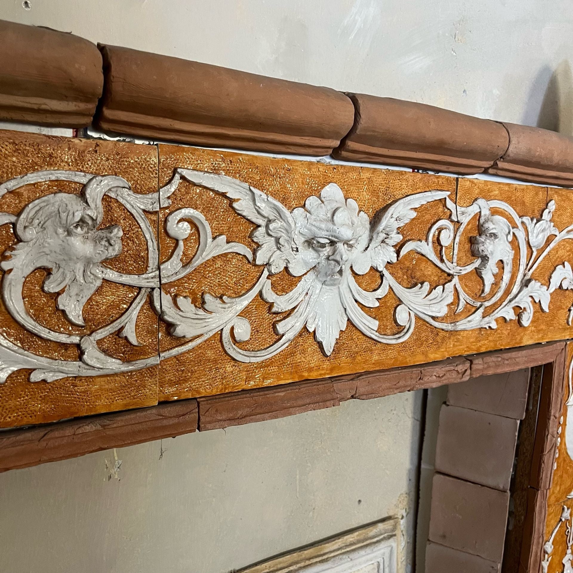 Majolica relief covering for fireplace